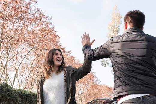 Two people greeting each other warmly